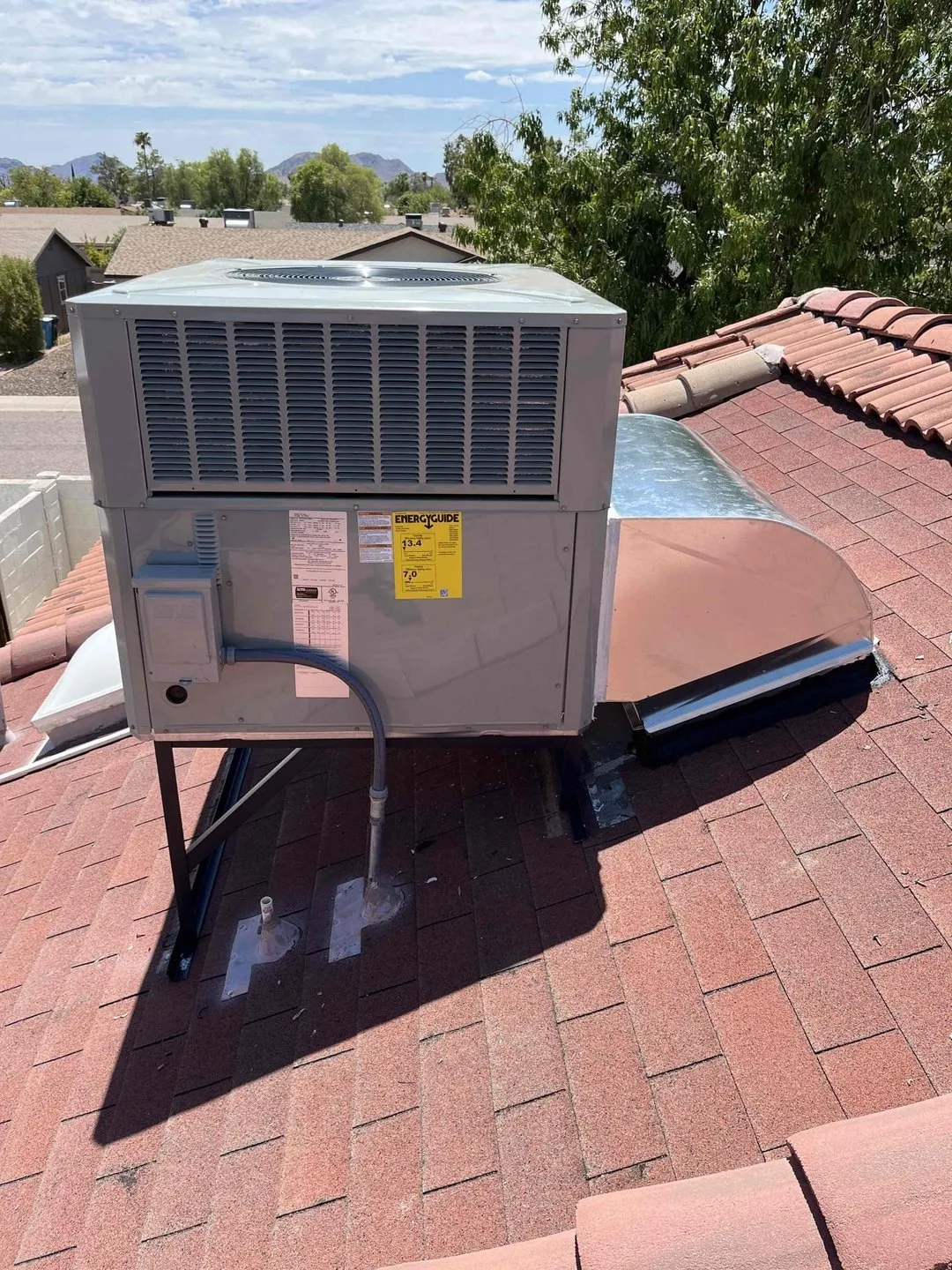A new rooftop package unit on a tile roof with the Valley skyline behind it